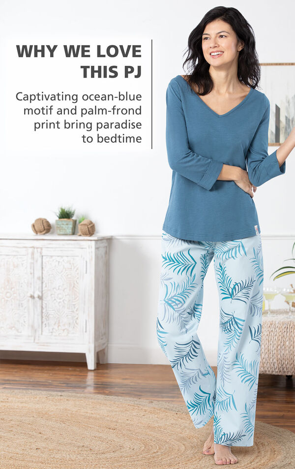 Model wearing Margaritaville Tropical Dreams Pajamas - Blue with the following copy: Captivating ocean-blue motif and palm-frond print bring paradise to bedtime image number 2