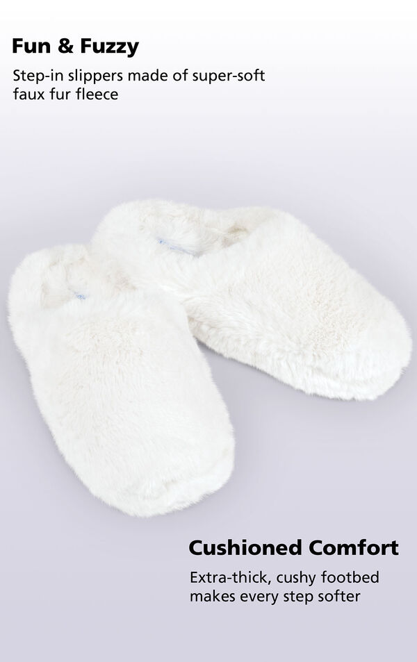 White Fuzzy Wuzzies slippers with the following copy: step-in slippers made of super-soft faux fur fleece. Extra-thick, cushy footbed makes every step softer image number 1