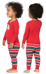 Model wearing Red and Green Christmas Stripe PJ for Infants, facing away from the camera and then to the side image number 1