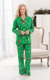 Model standing by chair wearing Green with Red Trim Charlie Brown Christmas Women's Pajamas image number 3
