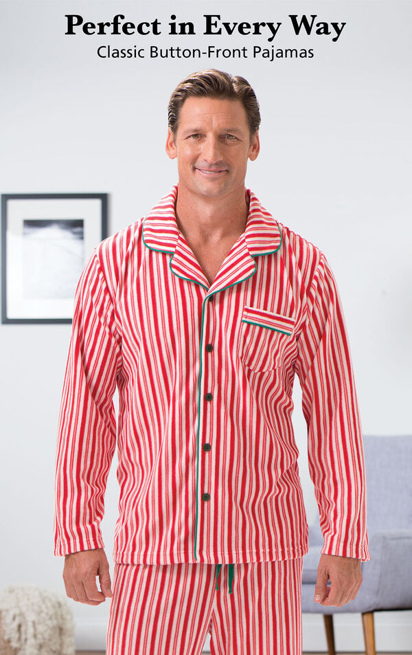 Model wearing Candy Cane Fleece Men's Pajamas by a chair with the following copy: Perfect in Every Way, Classic Button-Front Pajamas image number 2