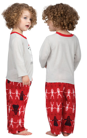 Model wearing Red Star Wars PJ for Toddlers, facing away from the camera and then to the side