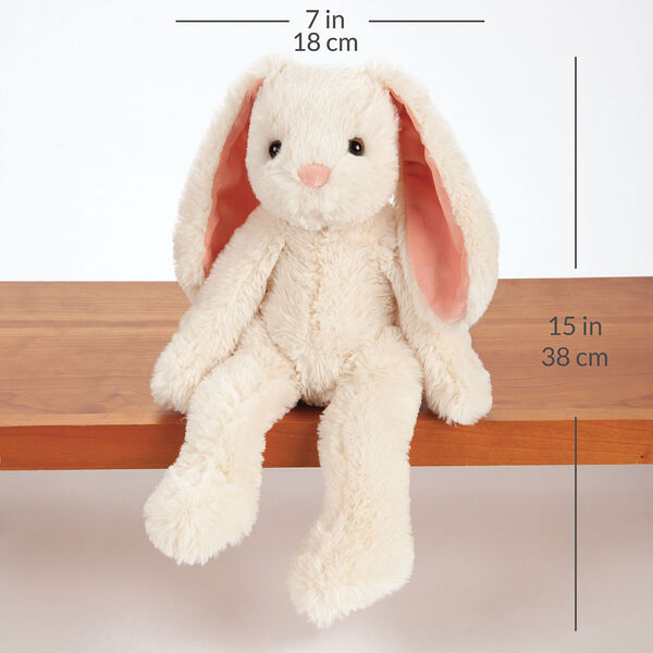 15" Buddy Bunny - Front View of ivory Bunny with pink ears and brown eyes sitting on a shelf  with a width measurement of 7 in or 18 cm and and length measurement of 15 in or 38 cm long.  image number 3