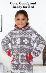 Girl wearing Nordic Fleece Hoodie-Footie by bed with the following copy: Sweet Dreams Start with PajamaGram. image number 1