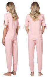 Model wearing Pink Tie Sleeve Jogger PJ for Women, facing away from the camera and then to the side image number 1