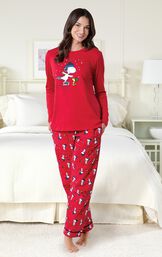 Model by bed wearing Red Snoopy and Woodstock Women's Pajamas image number 1