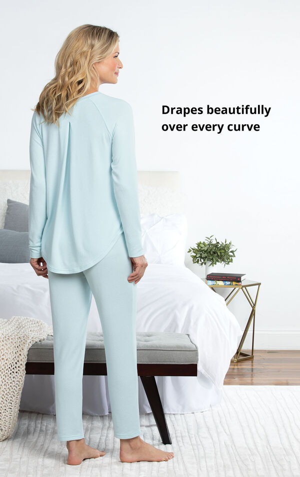 Model standing by bed wearing Blue Cloud Fine Pajamas with the following copy: Drapes beautifully over every curve image number 4