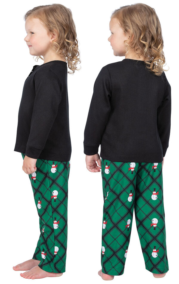 Model wearing Black and Green Snowman Argyle Henley PJ for Toddlers, facing away from the camera and then to the side image number 1