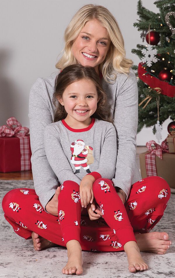 Mom and Toddler wearing matching gray and red St. Nick Pajamas, sitting by Christmas Tree image number 2