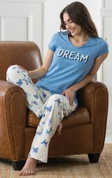 Model sitting in leather chair wearing Blue and White butterfly print Dream Pajamas image number 4