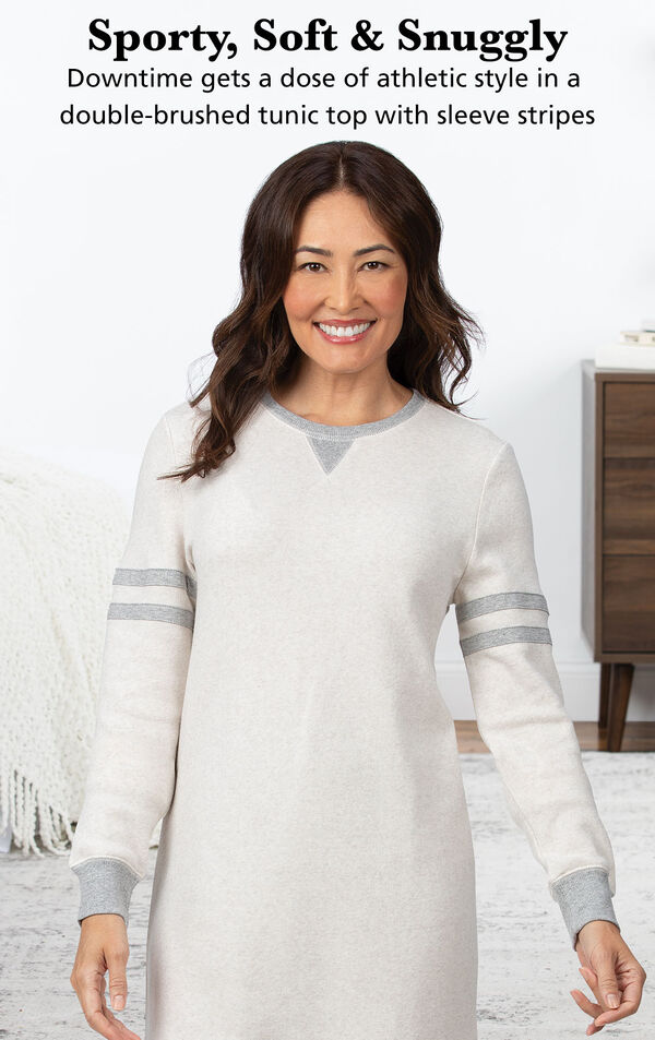 Model wearing Sporty Sweatshirt and Leggings PJ Set - Ivory/Gray by bed with the following copy: Sporty, Soft and Snuggly. Downtime gets a dose of athletic style in a double-brushed tunic top with sleeve stripes. image number 3