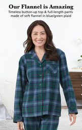 Model wearing Heritage Plaid Boyfriend Flannel Pajamas by bed with the following copy: Our Flannel is Amazing. Timeless button-up top and full-length pants made of soft flannel in blue/green plaid image number 3