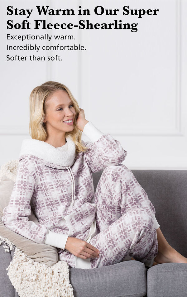 Model sitting on a couch wearing Chalet Shearling Rollneck Pajamas with the following copy: Stay warm in our Super-Soft Fleece-Shearling. Exceptionally warm, incredibly comfortable, softer than soft. image number 3