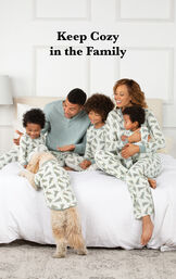 Family sitting on bed wearing Sage Green and White Balsam and Pine Matching Family Pajamas, with the following copy: Keep Cozy in the Family image number 1