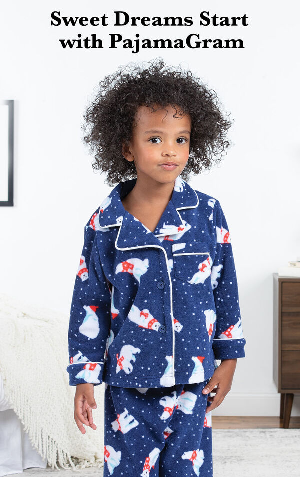 Polar Bear Fleece Toddler Pajamas by bed with the following copy: Sweet Dreams Start with PajamaGram image number 2