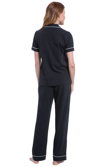 Model wearing Black Solid Short Sleeve Boyfriend PJ, facing away from the camera and then facing to the side