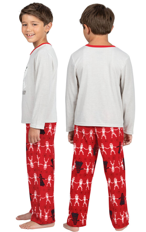 Model wearing Red Star Wars PJ for Kids, facing away from the camera and then to the side image number 1