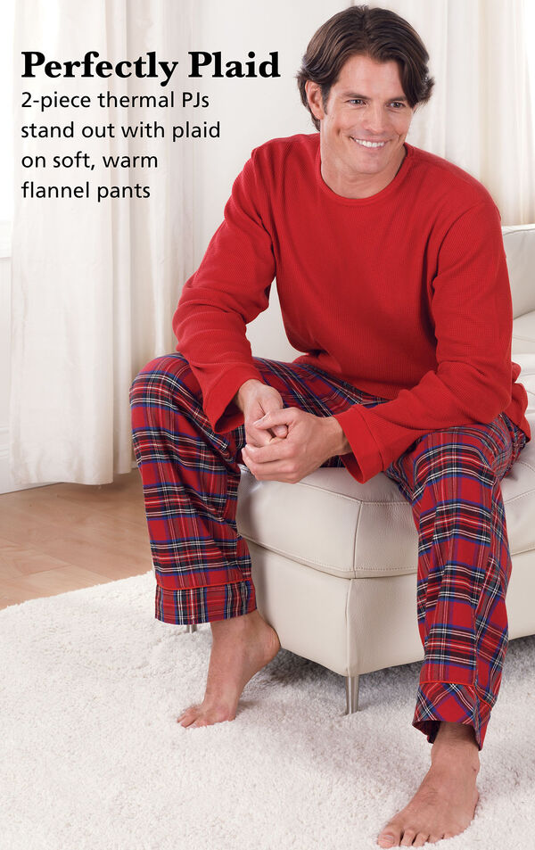 Model wearing Stewart Plaid Thermal-Top Men's Pajamas sitting on a chair with the following copy: Perfectly Plaid. 2-piece thermal PJs stand out with plaid on soft, warm flannel pants image number 2