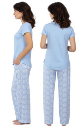 Model wearing Light Blue Paw Print Heart PJ for Women, facing away from the camera and then to the side image number 1