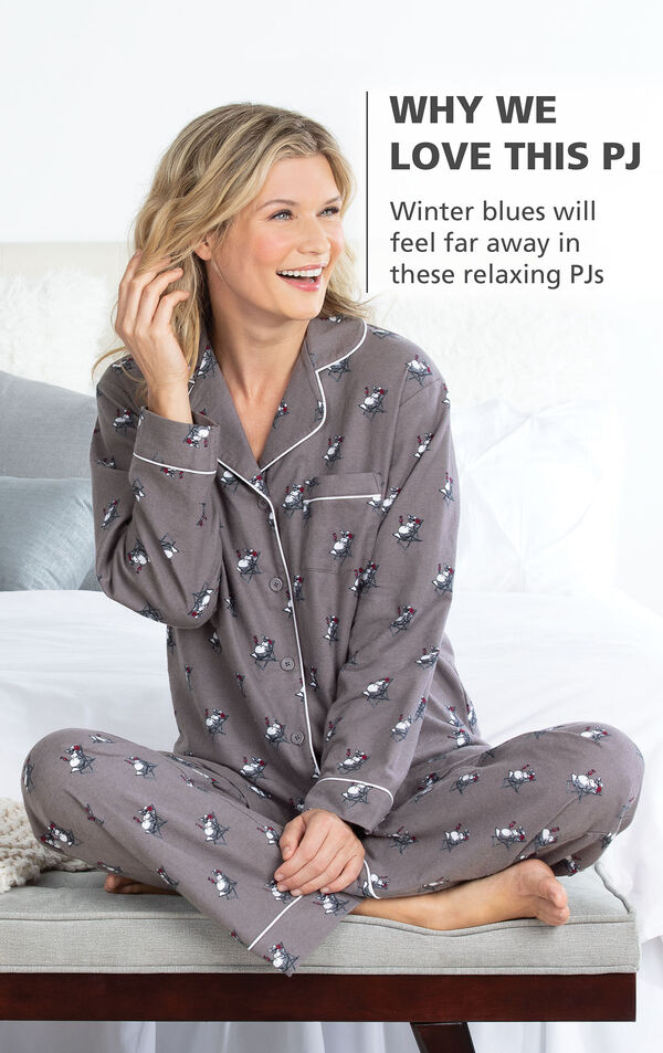 Model sitting on bed wearing Gray Snowman print Margaritaville Flannel Boyfriend Pajamas with the following copy: Winter blues will feel far away in these relaxing PJs image number 2