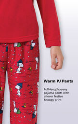 Close-up of warm red PJ pants with the following copy: full-length jersey pajama pants with allover festive Snoopy print. image number 2
