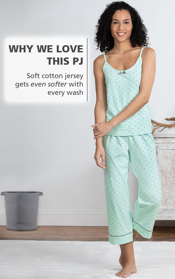 Model standing by bed wearing Mint Polka-Dot Cami and Capri Pajamas with the following copy: Soft cotton jersey gets even softer with every wash image number 3