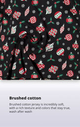 Black fabric with christmas ornament print with the following copy: brushed cotton jersey is incredibly soft, with a rich texture and colors that stay true image number 4