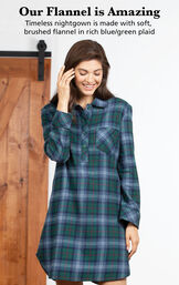 Model wearing Heritage Plaid Sleepshirt by bed with the following copy: Our Flannel is Amazing. Timeless nightgown is made with woven, yarn dyed flannel in rich blue/green plaid image number 2