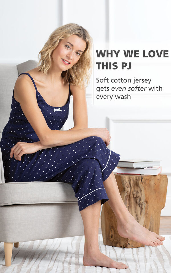 Model sitting on couch wearing Polka-Dot Cami and Capri Pajamas - Navy with the following copy: Soft cotton jersey gets even softer with every wash image number 2