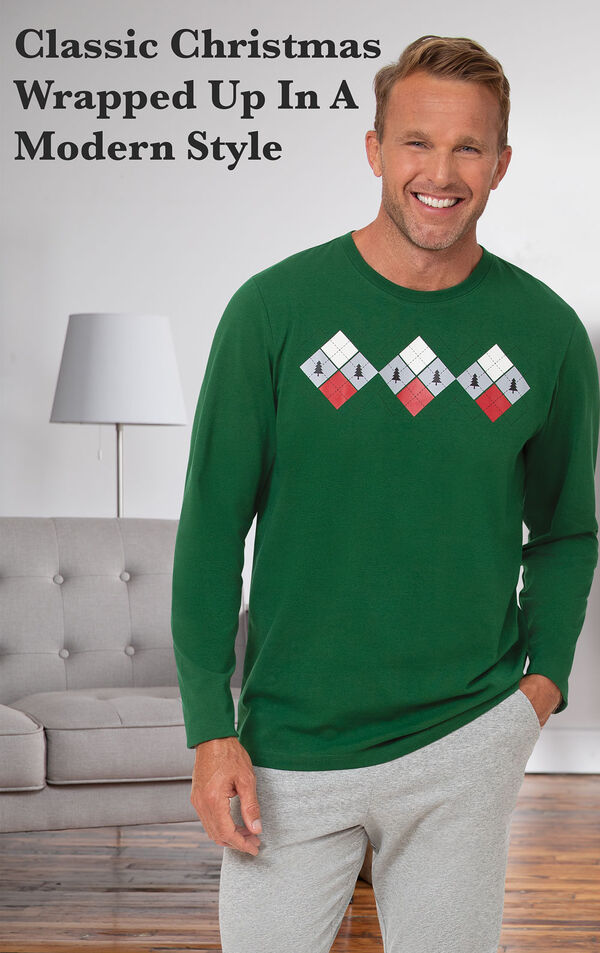 Model standing by couch wearing Green and Gray Holiday Argyle Men's Pajamas with the following copy: classic christmas wrapped up in a modern style image number 2