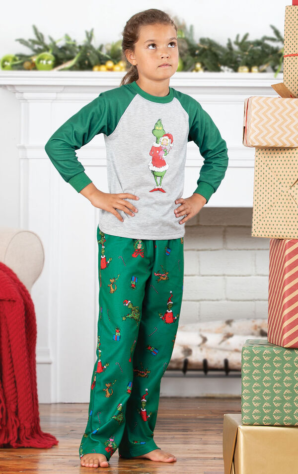 Model wearing Dr. Seuss The Grinch Girls Pajamas standing by the fireplace image number 2