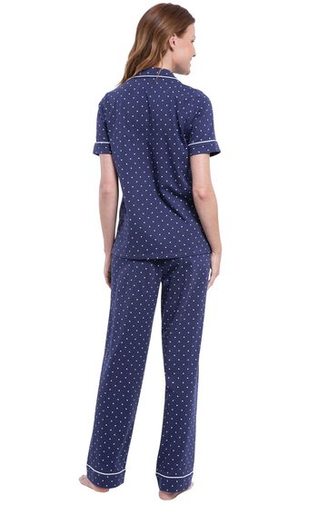 Model wearing Navy Blue and White Polka Dot Short Sleeve Button-Front PJ for Women, facing away from the camera