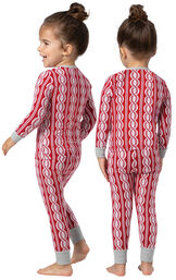 Model wearing Red and White Peppermint Twist PJ for Toddlers, facing away from the camera and then to the side image number 1