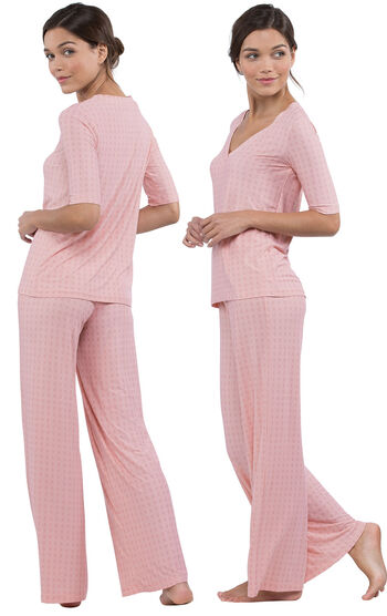 Model wearing Light Pink Stretch Knit Geo Print PJ for Women, facing away from the camera and then facing to the side