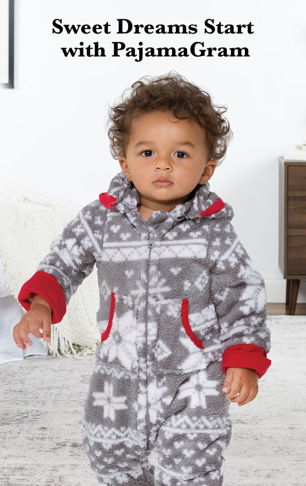 Infant wearing Nordic Fleece Hoodie-Footie by bed with the following copy: Sweet Dreams Start with PajamaGram. image number 1