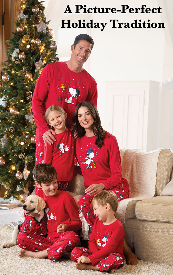 Parents and children and dog wearing Red Snoopy and Woodstock Matching Family Pajamas. Headline: A Picture-Perfect Holiday Tradition. image number 1