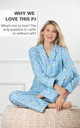 Model sitting on bed wearing Blue with Margarita Print Margaritaville Flannel Boyfriend Pajamas - Cocktail O'Clock and the following copy: The only question is - with or without salt? image number 2
