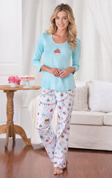 Model wearing Light Blue and White Happy Birthday Pajamas, standing by couch image number 1
