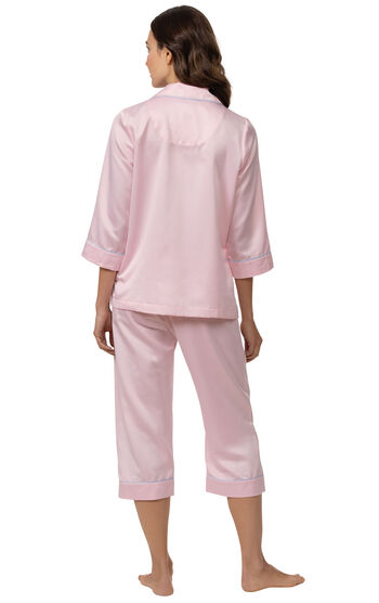 Model wearing Light Pink Satin Button-Front Capri PJ with Blue Trim for Women facing away from the camera