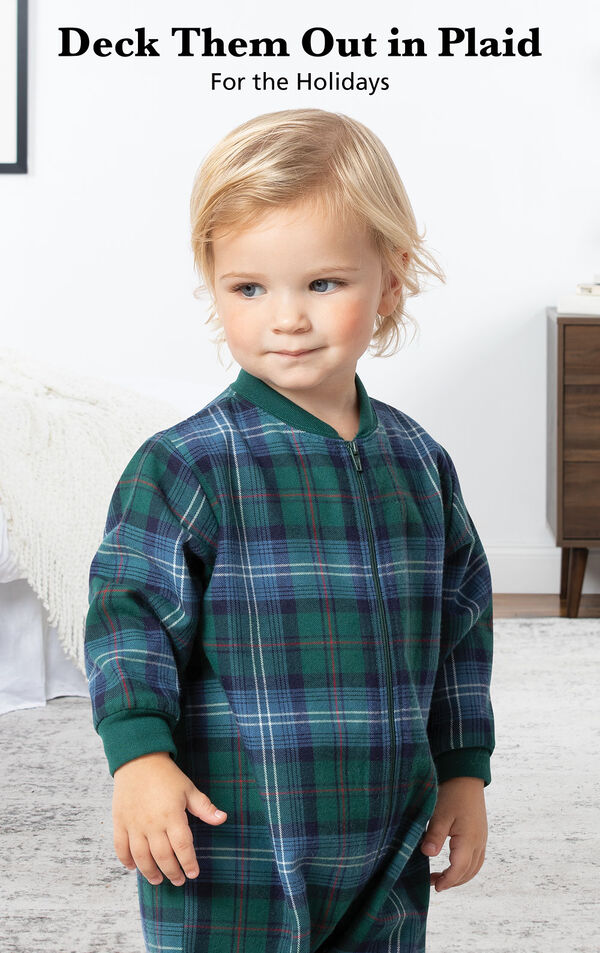Infant boy wearing Heritage Plaid Infant Onesie Pajamas by bed with the following copy: Deck Them Out in Plaid for the Holidays image number 2