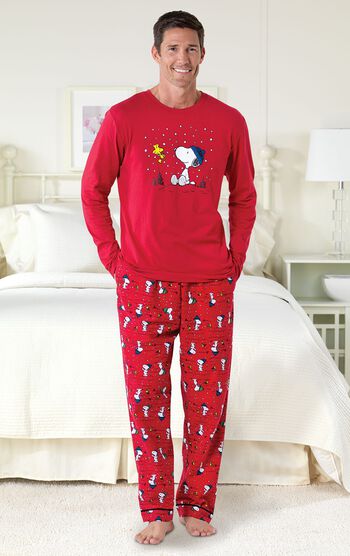 Model standing by bed wearing Red Snoopy and Woodstock Men's Pajamas