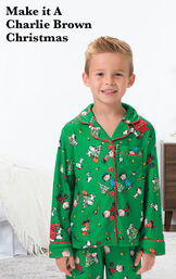 Boy wearing Charlie Brown Christmas Boys Pajamas by bed with the following copy: Make it a Charlie Brown Christmas. image number 1