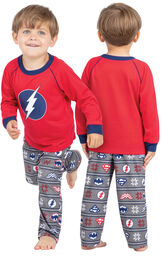 Model wearing Red and Blue Justice League PJ for Toddlers, facing away from the camera and then to the side image number 1