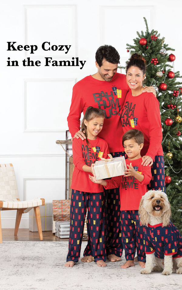 Family standing by Christmas Tree wearing Red and Blue matching Christmas Presents Family Pajamas with the following copy: Keep Cozy in the Family image number 1