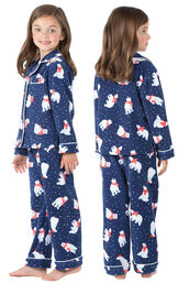 Model wearing Navy Polar Bear Fleece Button-Front PJ for Girls, facing away from the camera and then facing to the side image number 1