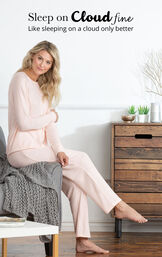 Model sitting on chair wearing Light Pink Cloud Fine Pajamas with the following copy: Sleep on Cloud fine, like sleeping on a cloud only better image number 2