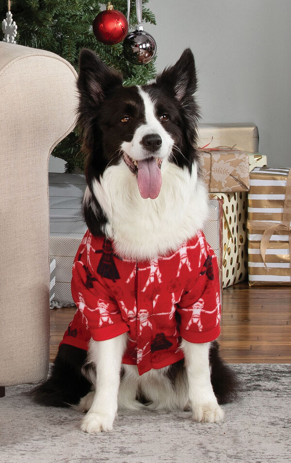 Dog sitting by Christmas Tree wearing Red Star Wars Pajamas