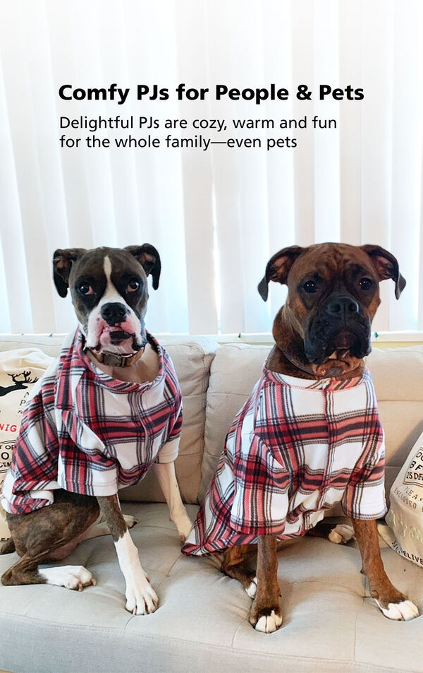 Two dogs sitting on couch wearing Red and White Plaid Fireside Fleece PJs with the following copy: Comfy PJs for People and Pets - delightful PJs are cozy, warm and fun for the whole family- even pets image number 2