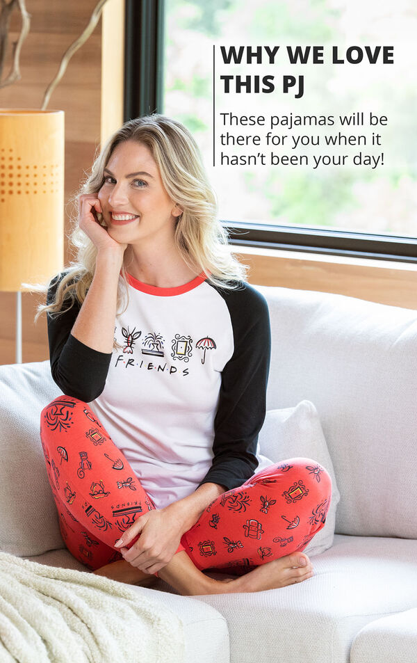 Woman sitting on couch wearing Black and Red Friends Jogger PJs with the following copy: These pajamas will be there for you when it hasn't been your day