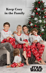 Family sitting by Christmas Tree wearing Red Star Wars Matching Family Pajamas with the following copy: keep Cozy in the Family image number 1